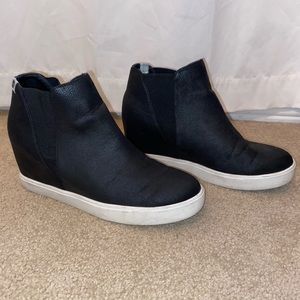 Black slip-on sneakers with a built in heel